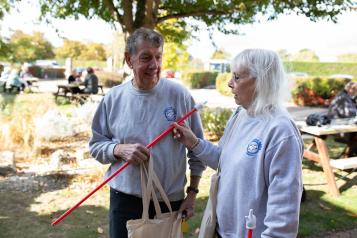 Two people outside an event chatting to each other